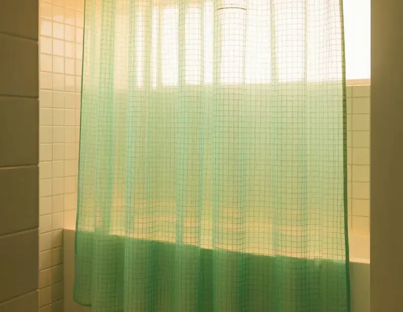 Small bathroom shower curtain mistake: don't block light with a solid curtain